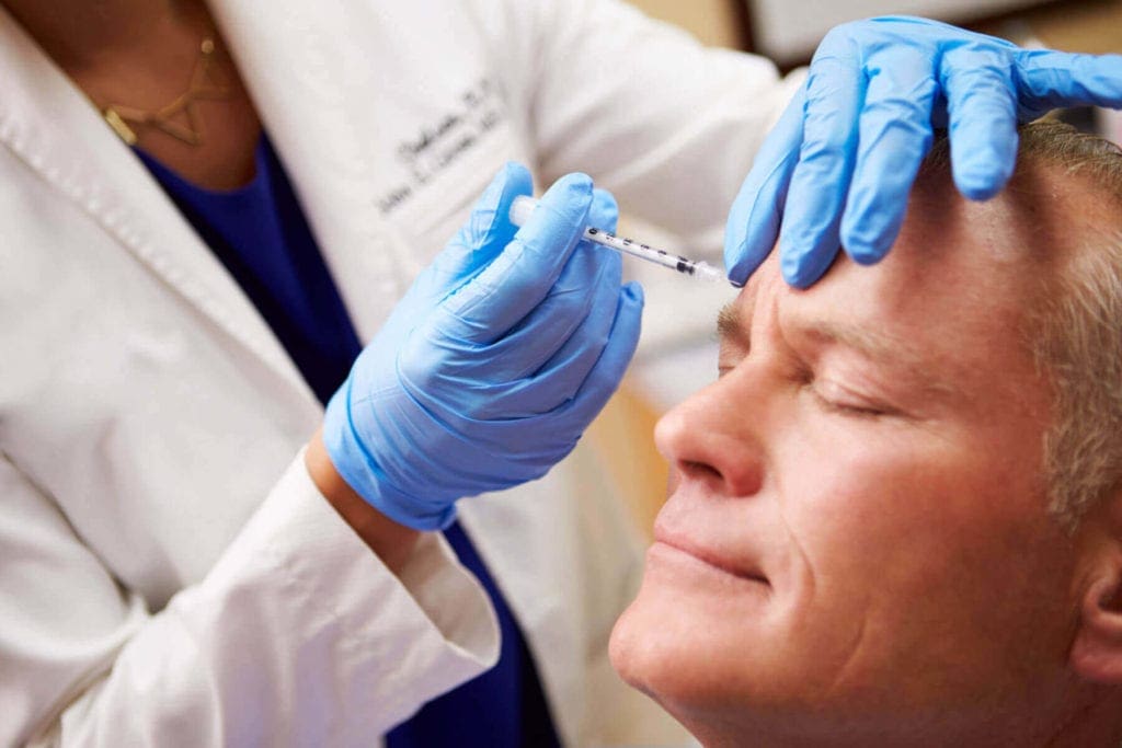man getting botox injections